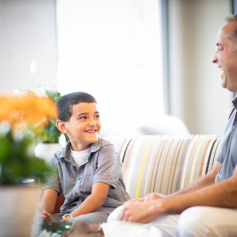 Dr. Comella explaining how a palatal expander works to a young patient and his mom in Rochester, NY